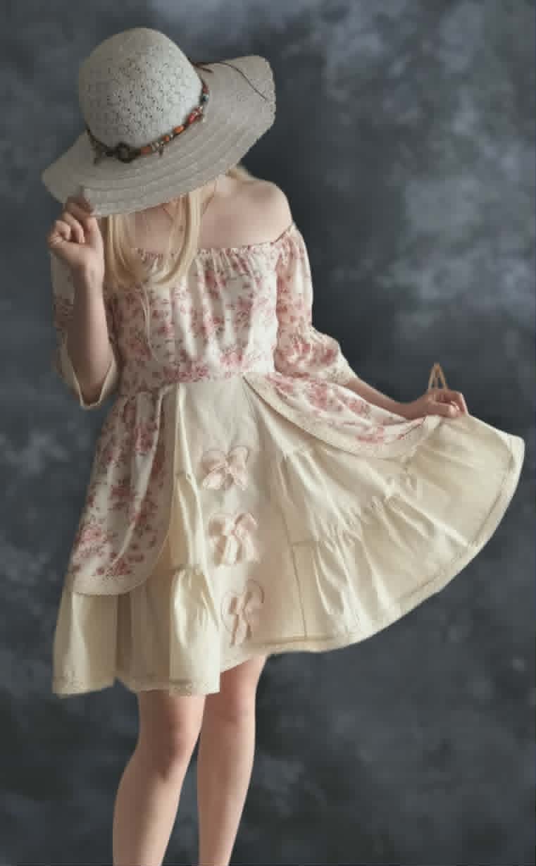 Woman wearing a vintage-style floral dress and wide-brimmed straw hat, viewed from behind against a gray textured background