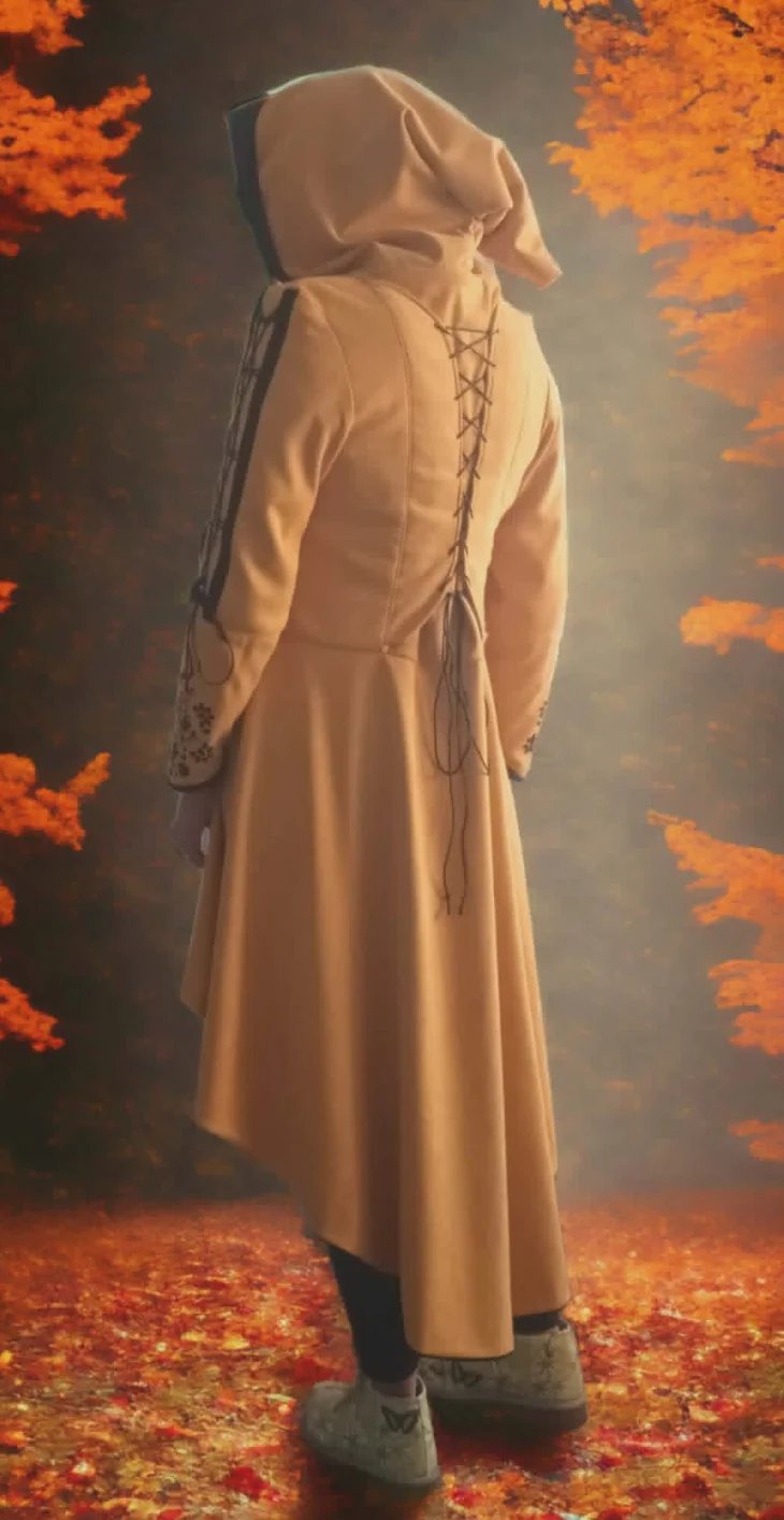 Figure in cream hooded robe with laced back standing against fiery orange autumn foliage background