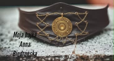 Ornate gold pendant on decorative chain with leather cuff, featuring circular mandala-like design