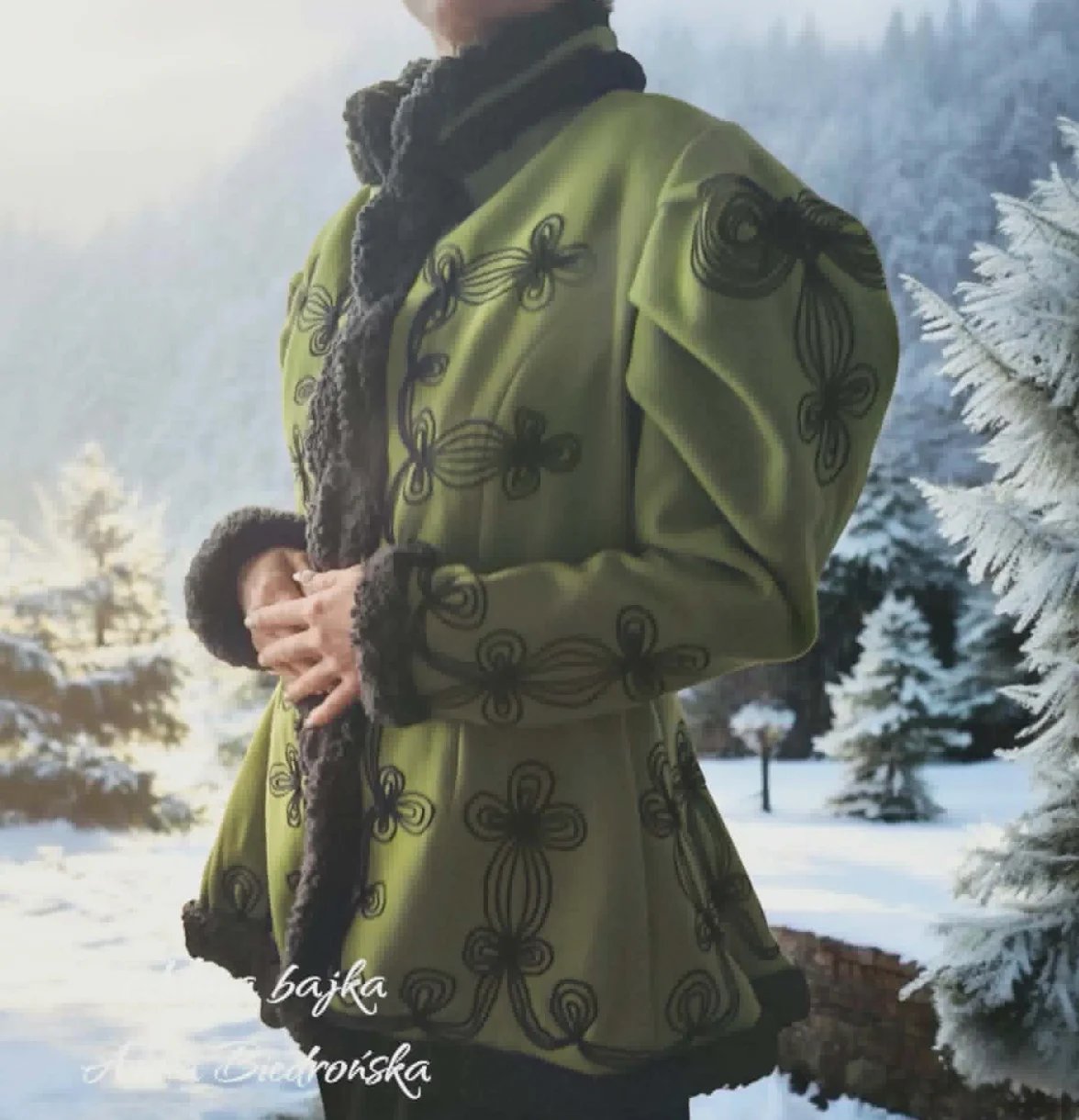 Person wearing ornate olive-green coat with decorative patterns, holding a child, in a snowy forest landscape