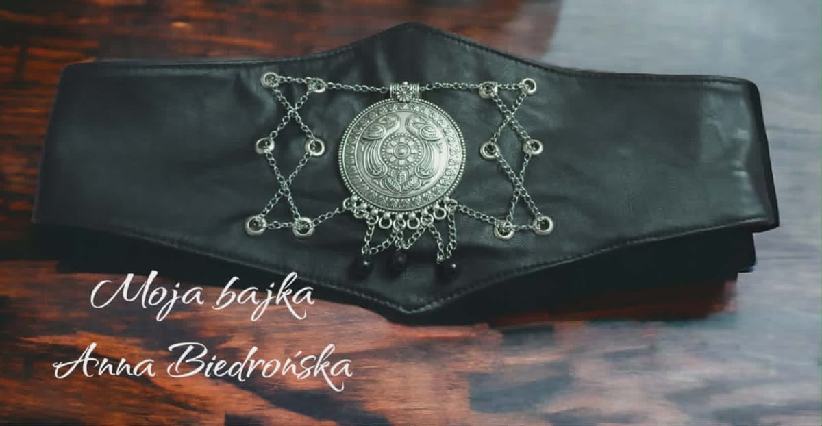 Black leather belt with ornate silver medallion and chain details, branded Moja Bajka Anna Ciedronska