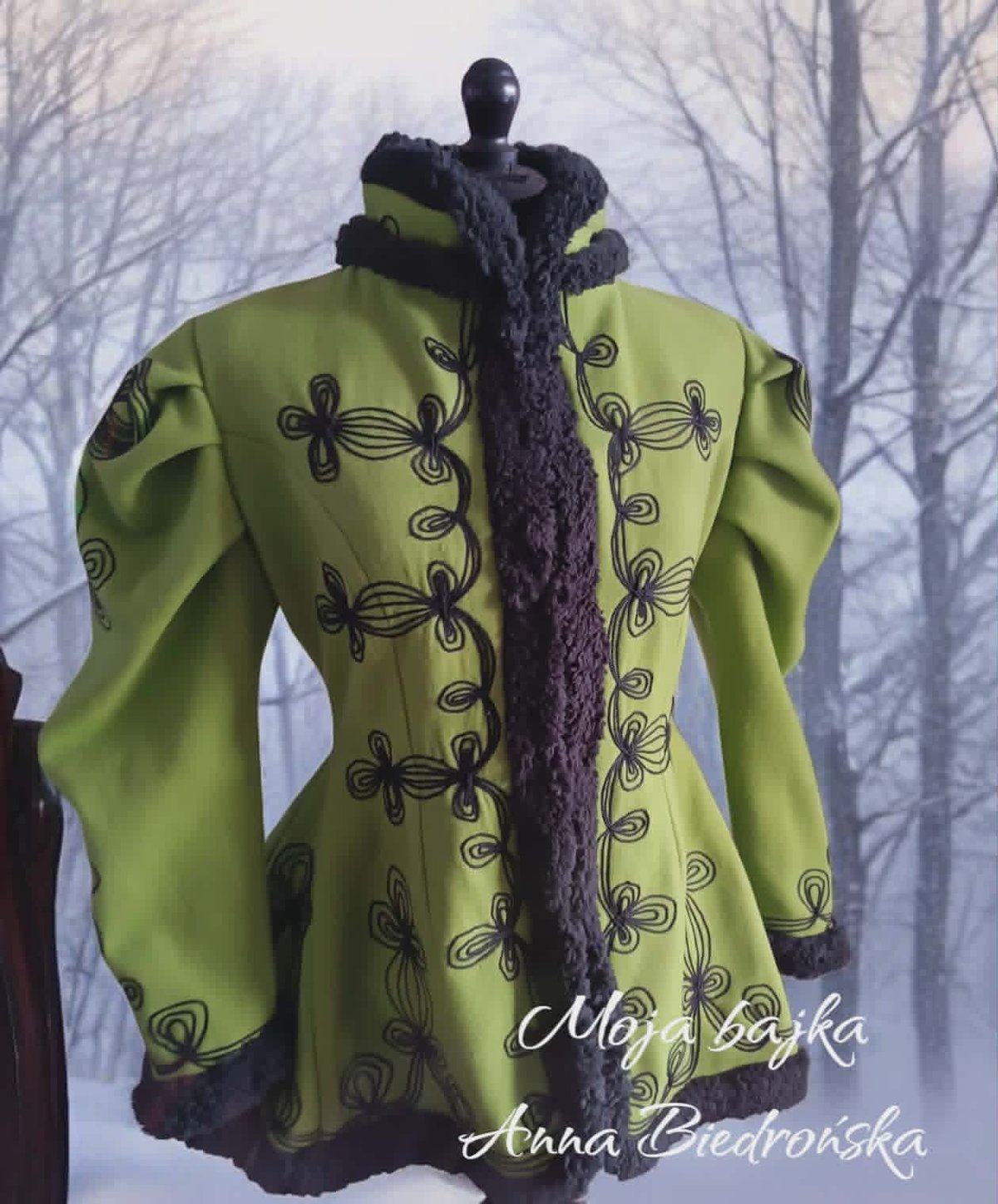 Lime green jacket with black embroidered butterfly designs and dark purple scarf collar, displayed on mannequin against bare trees background