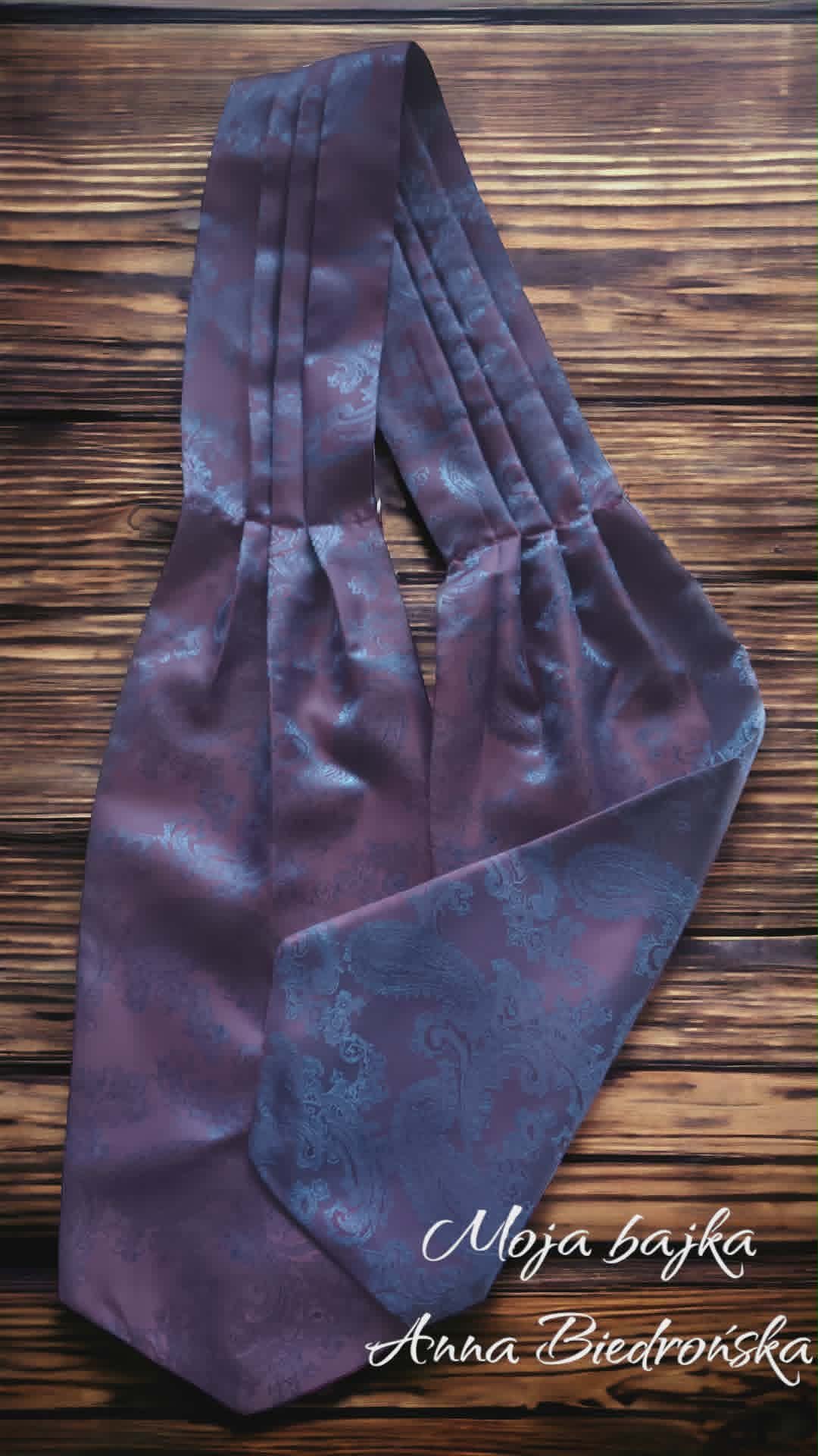 Purple fabric tote bag with ornate pattern displayed on wooden background, credited to Moja Bajka and Anna Biedronska