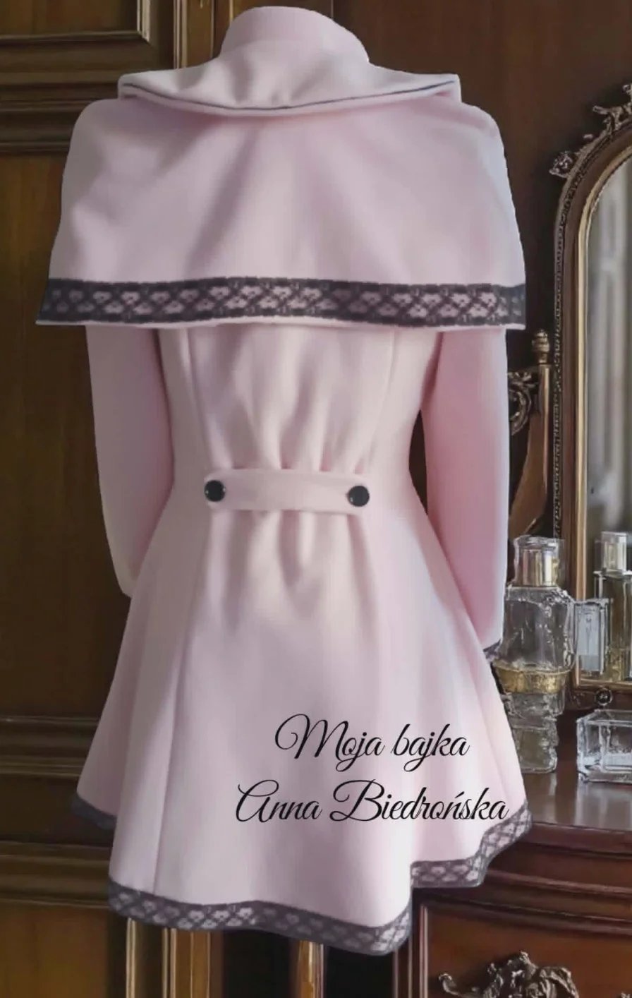 Pink dress on mannequin with draped shawl and patterned trim, displaying personalized text on back