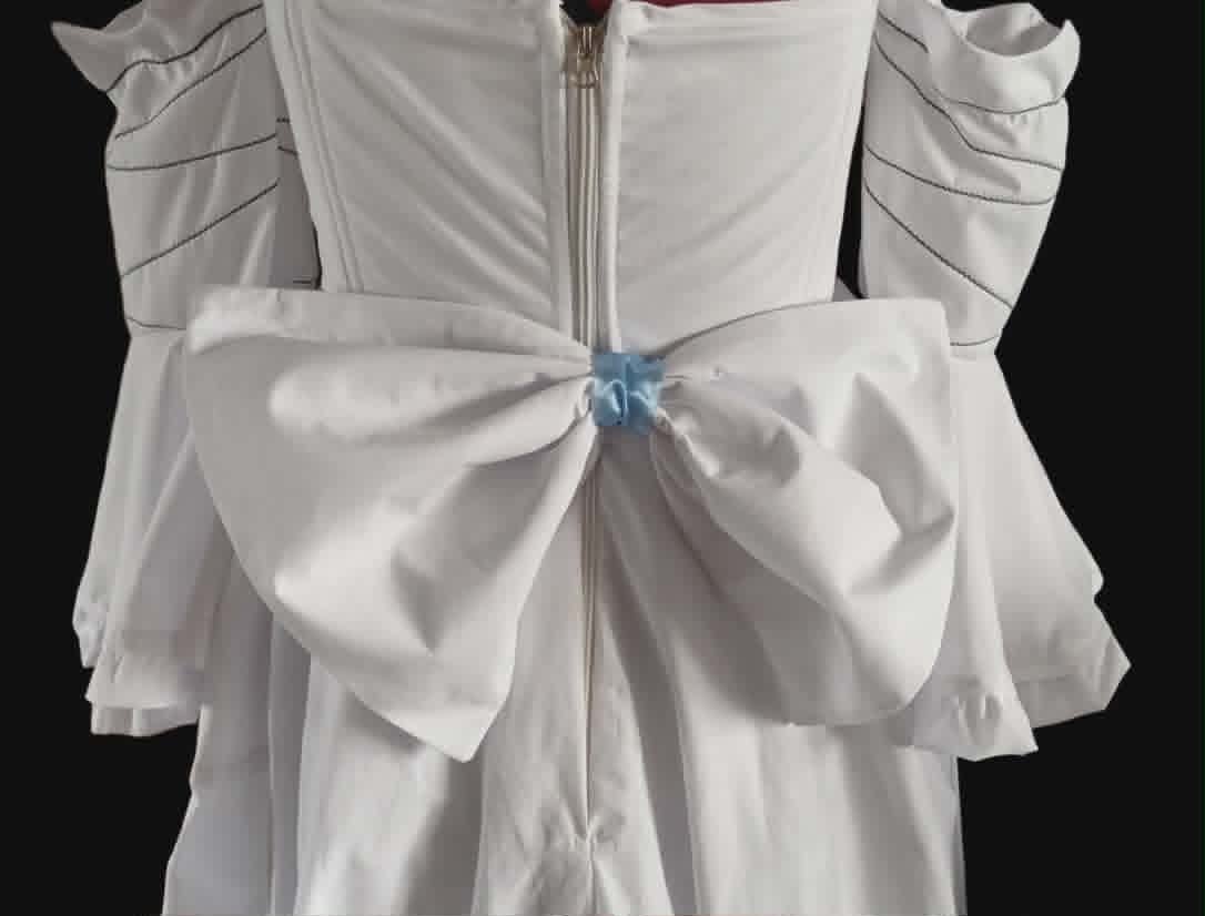 Back view of white formal dress with large bow detail and center back zipper against black background