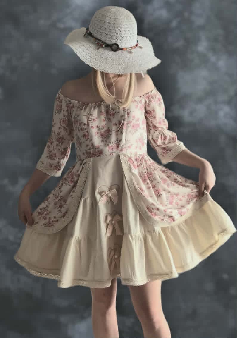 Woman wearing a vintage-style floral dress with a cream-colored wide-brimmed hat, viewed from behind against a gray background