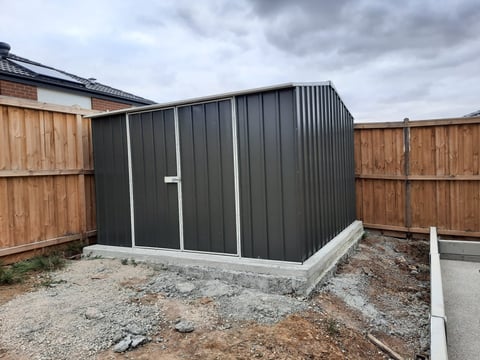 Dark grey corrugated metal garden shed assembled on concrete base by Home and Asset Management in Geelong