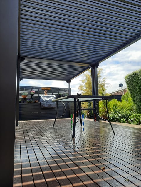 Louvered pergola over timber deck with outdoor dining set - Geelong handyman pergola build with garden view