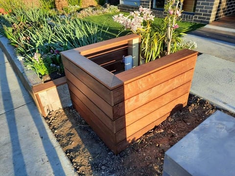 Custom timber planter box with horizontal slats built by Geelong handyman in modern garden setting