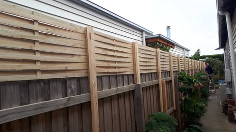 Timber fencing installation - horizontal slat fence with vertical posts built in Geelong residential backyard