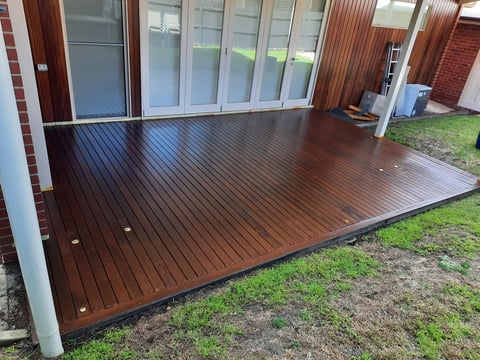 Timber deck restoration - large brown hardwood deck extending from brick home, Geelong deck repair project