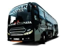 Black coach bus with NASA branding and graphics on the side, viewed from a three-quarter angle