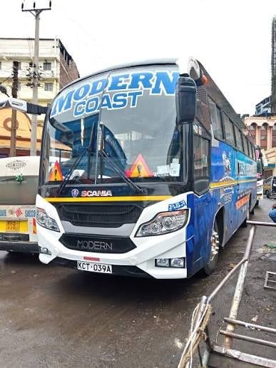 Modern Coast intercity bus on an urban street