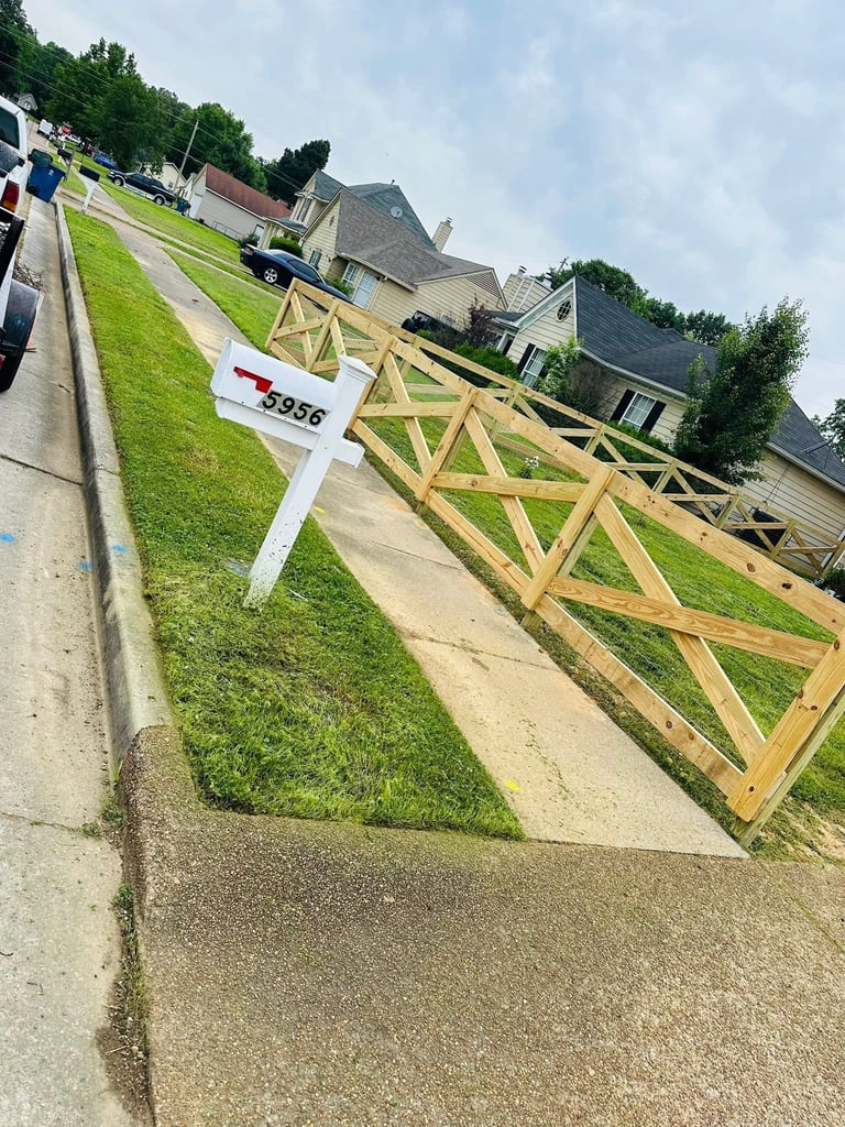 Wooden ranch-style gate with X-pattern design on residential driveway, with white mailbox labeled 5958 in foreground