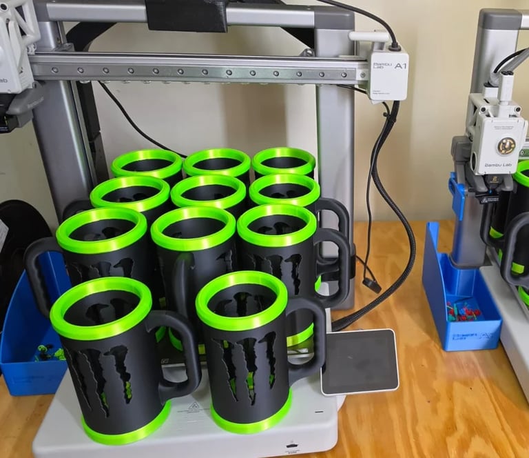 3D printer with bright green and black cylindrical spools organized on the build platform in rows