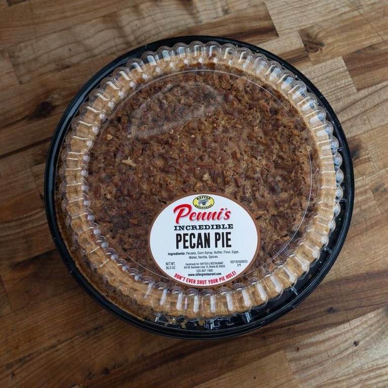 Penni's Incredible Pecan Pie in a disposable clear container on a wooden surface