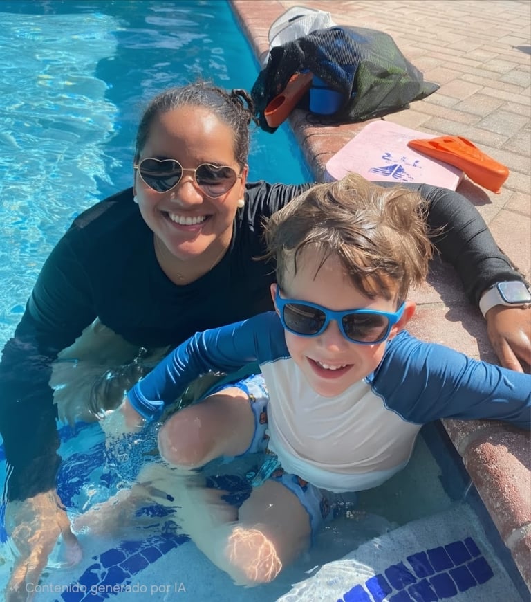 Adult and child in swimming pool wearing sunglasses and flotation aids, both smiling at the camera