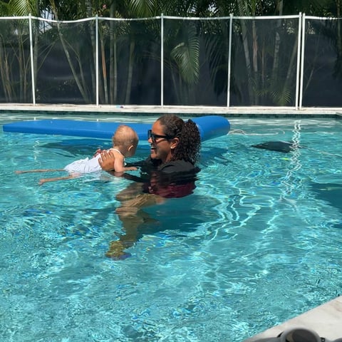 Infant swim lesson photo 1 — adult instructor teaching baby in a private pool
