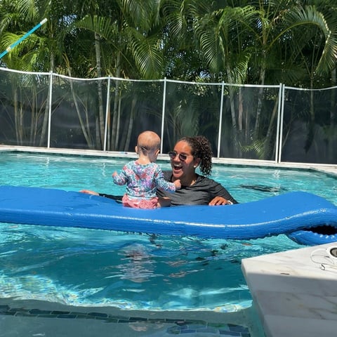 Infant swim lesson photo 2 — adult instructor teaching baby in a private pool