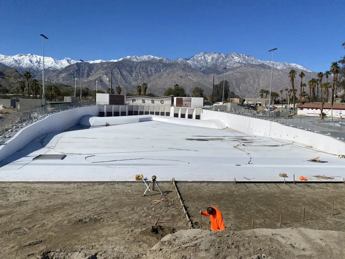 Construction site grading with machinery in a desert landscape