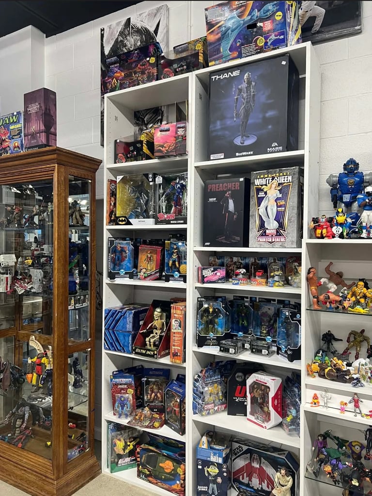 Shelving unit and glass display cabinet filled with collectible action figures, anime merchandise, and pop culture items
