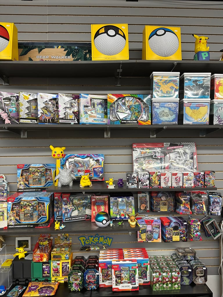 Retail display of Pokemon trading cards and merchandise on shelves with yellow signage and figurines