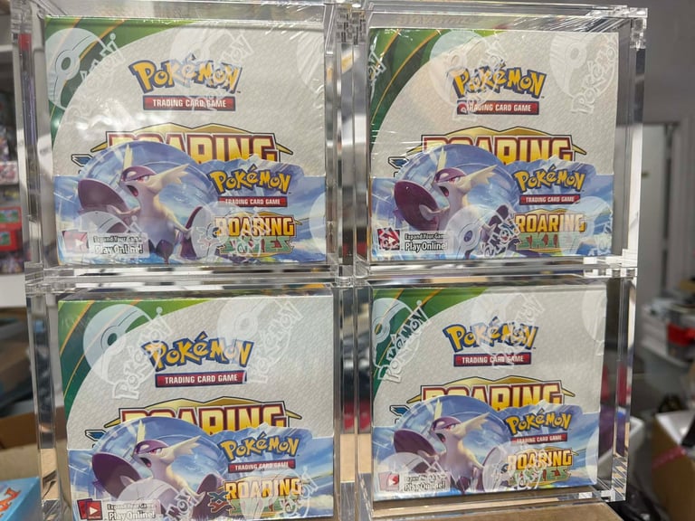 Four sealed Pokemon Trading Card Game Roaring Skies booster boxes displayed on store shelf