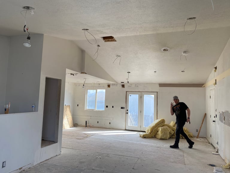 Worker on site in an unfinished basement renovation