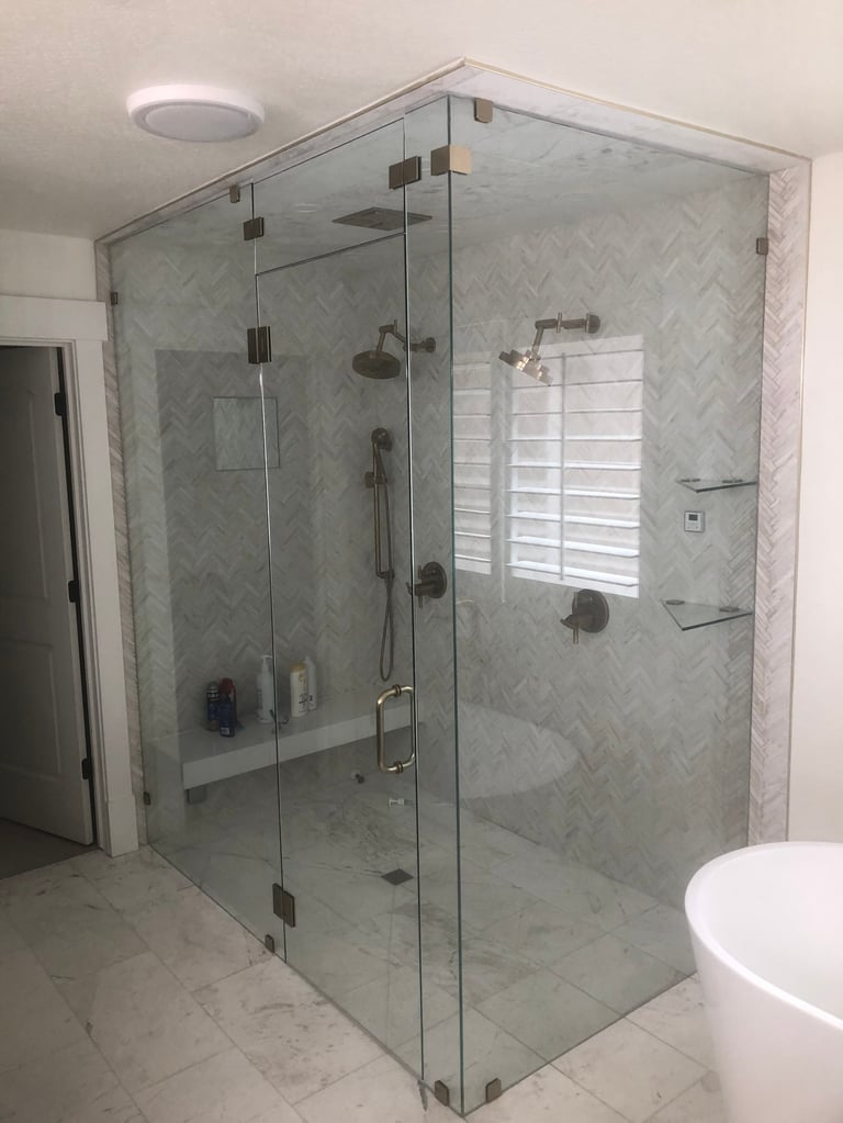 Modern bathroom with marble herringbone walk-in shower and brushed nickel fixtures