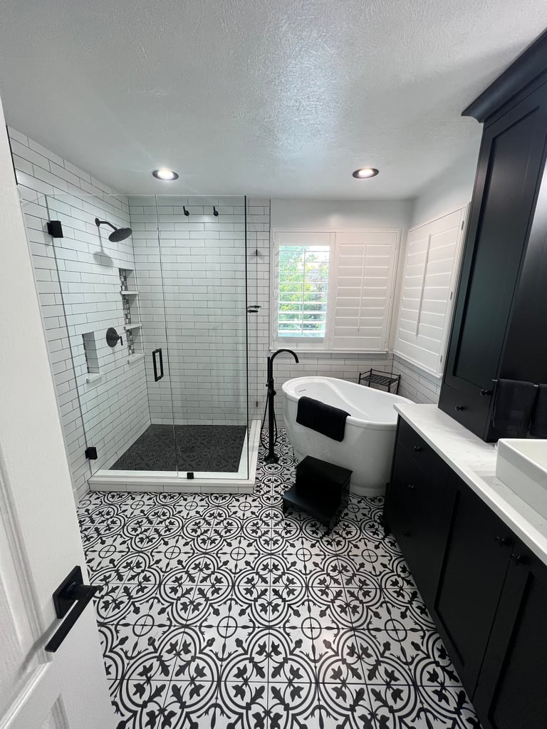 Black and white patterned floor tile in a renovated bathroom