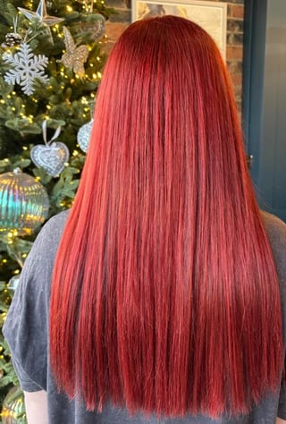 Person with long straight red hair viewed from behind