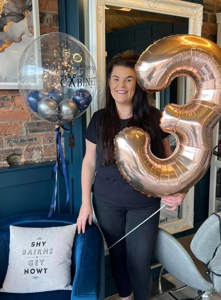 Nicola celebrating 3 years of The Hair Cabinet with a gold balloon
