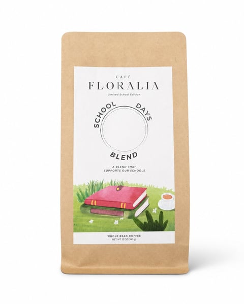 Cafe Floralia School Days Blend whole bean coffee bag with kraft paper packaging and illustration of stacked books on grass