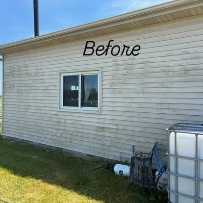Before photo of a mobile home exterior with weathered siding, window, and scattered items on the ground
