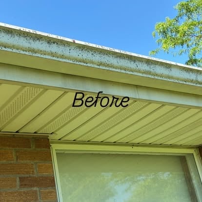 Before: Dirty gutter and roof overhang with moss and algae buildup on metal and siding