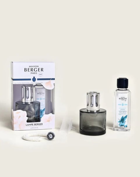 Maison Berger fragrance diffuser set with boxed lamp, dark glass burner bottle, and clear refill liquid on white background