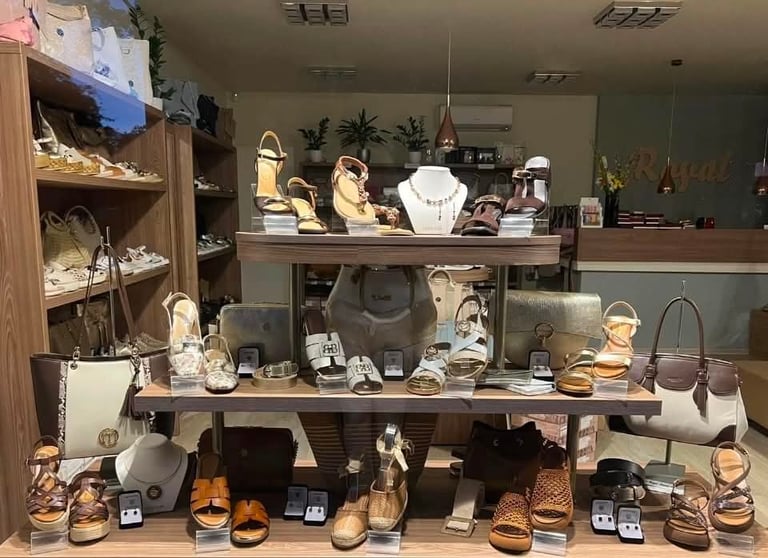 Jewelry and accessories retail display with shoes, handbags, necklaces, and watches arranged on shelves and tables