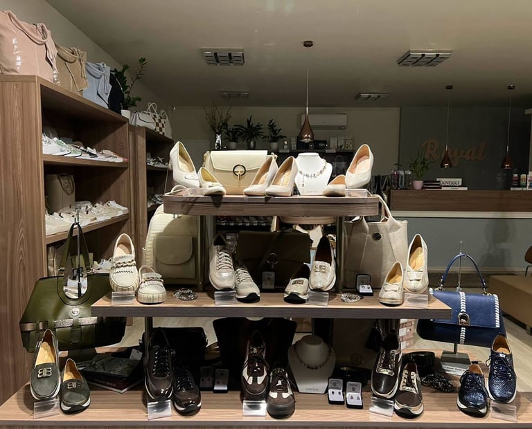 Retail shoe store display with shelving units showing various footwear styles in beige and black