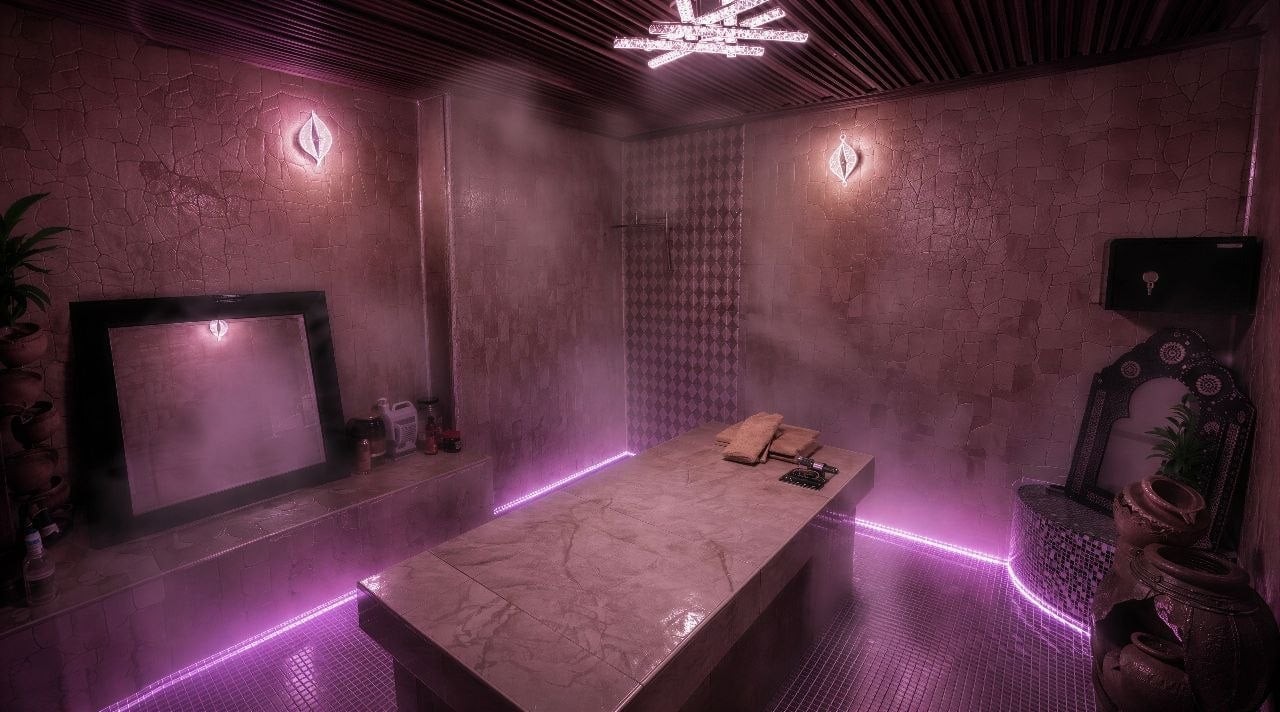 Futuristic purple-lit room with neon strips, central table, monitors, and sci-fi aesthetic
