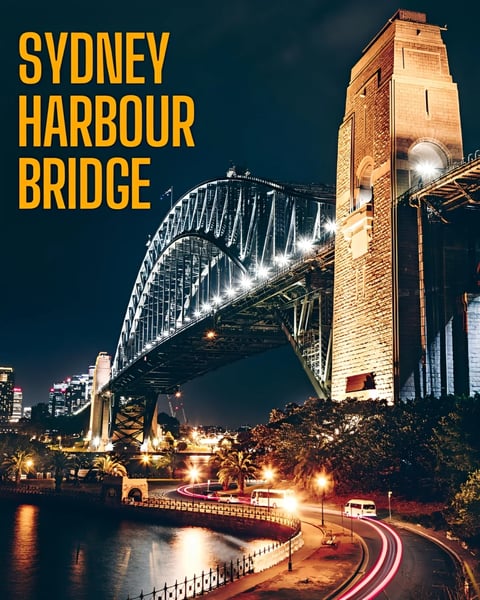 Sydney Harbour Bridge illuminated at night with arched steel structure and brick tower, water reflection and city lights below