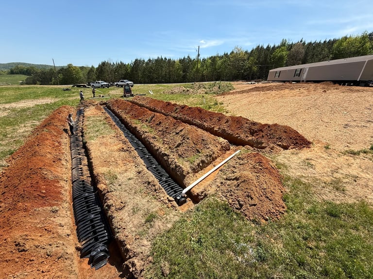 Drainage lines and trenches being installed across a field