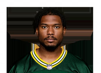 Professional headshot of a man wearing a green and yellow sports jersey with an NFL logo