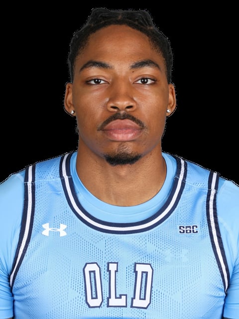 Headshot of a male basketball player wearing a light blue jersey with OLD lettering, SBC logo, and Under Armour branding