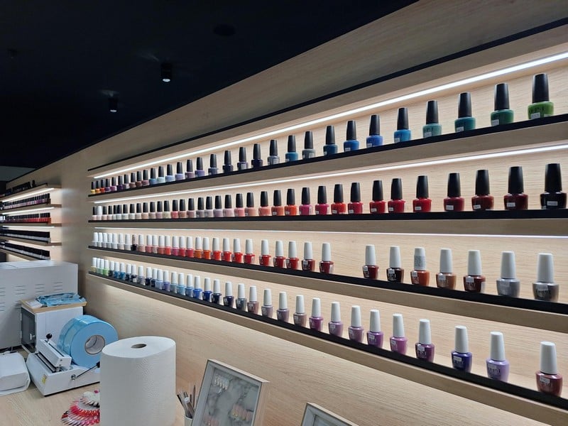 Wall display of nail polish bottles organized in rows