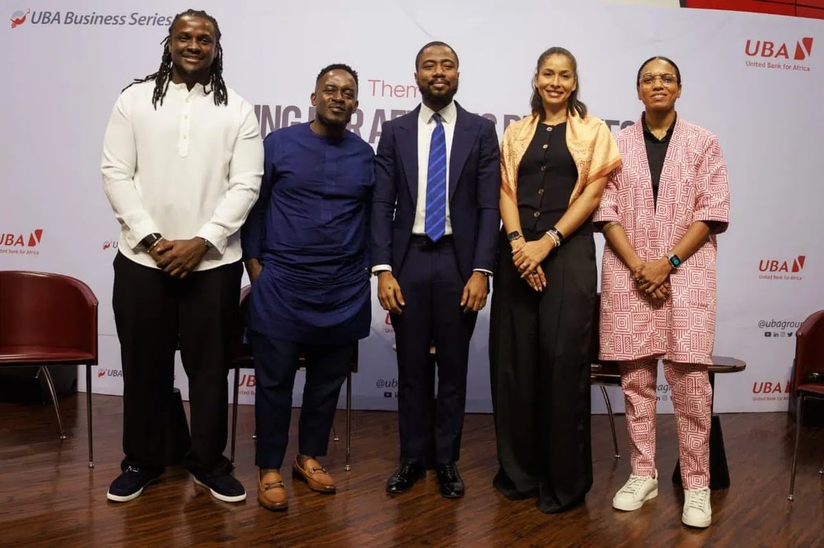 Five professionals standing together at a UBA Business Series event panel discussion