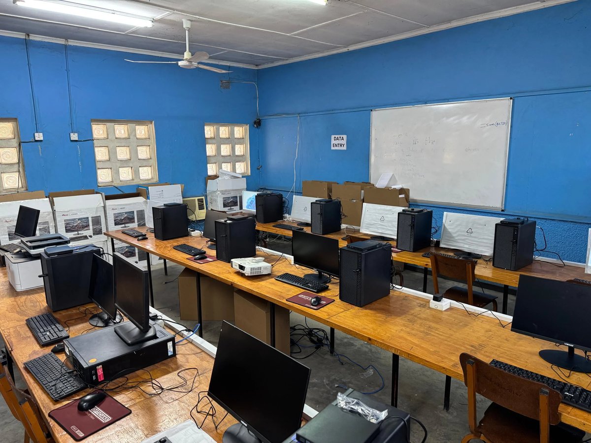 Computer lab classroom with blue walls and desktop computers