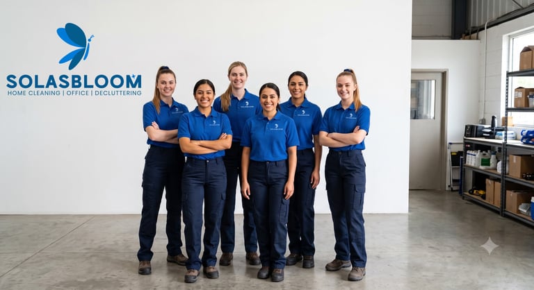 Six Solasbloom team members in blue uniforms standing with crossed arms in an office interior