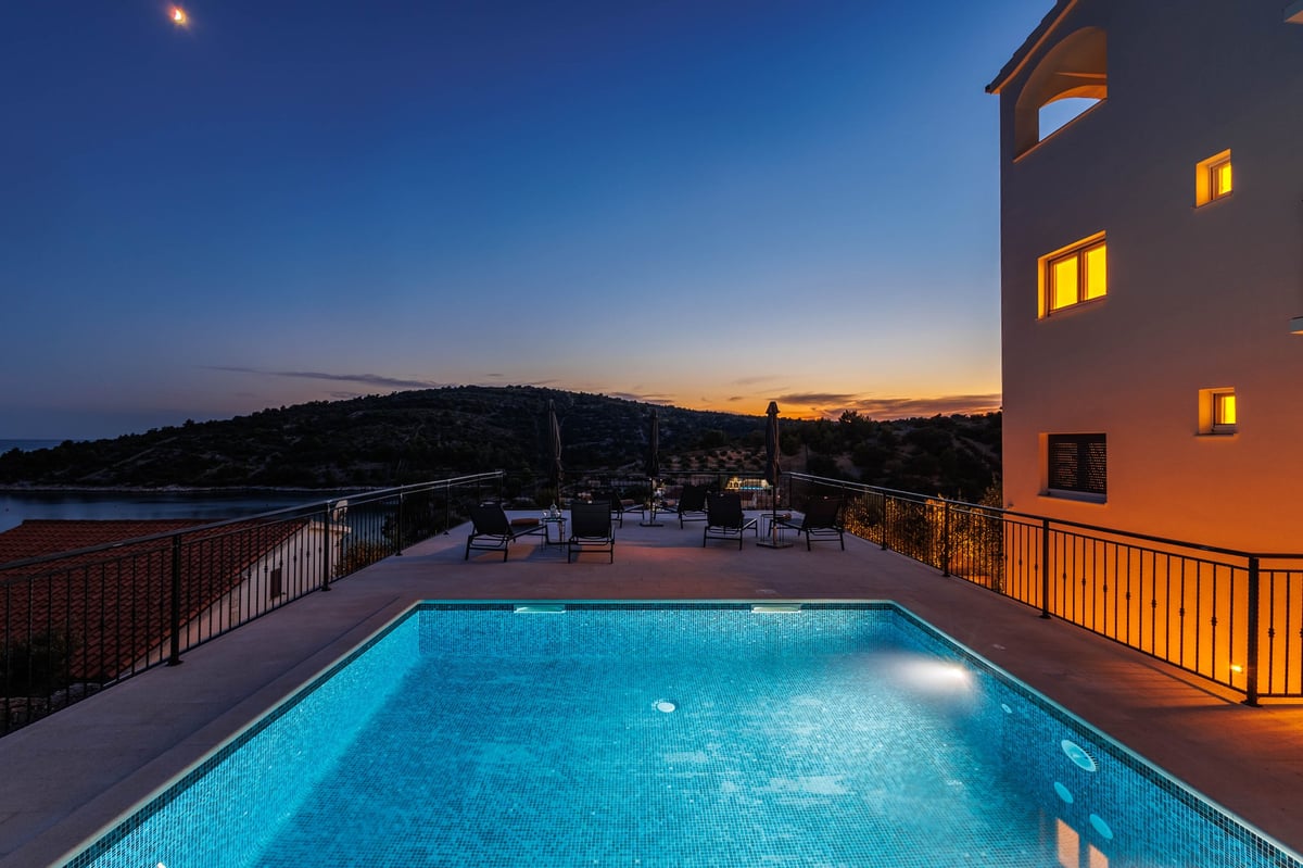 Private pool on rooftop terrace at dusk overlooking the Adriatic