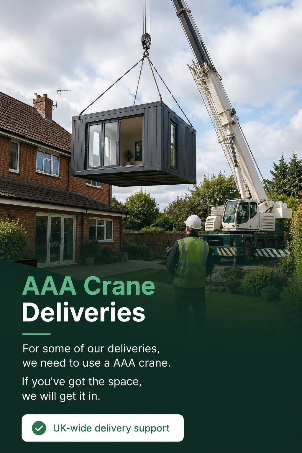 AAA Crane Deliveries — mobile crane lifting a modular black room module over a brick house in a residential garden setting