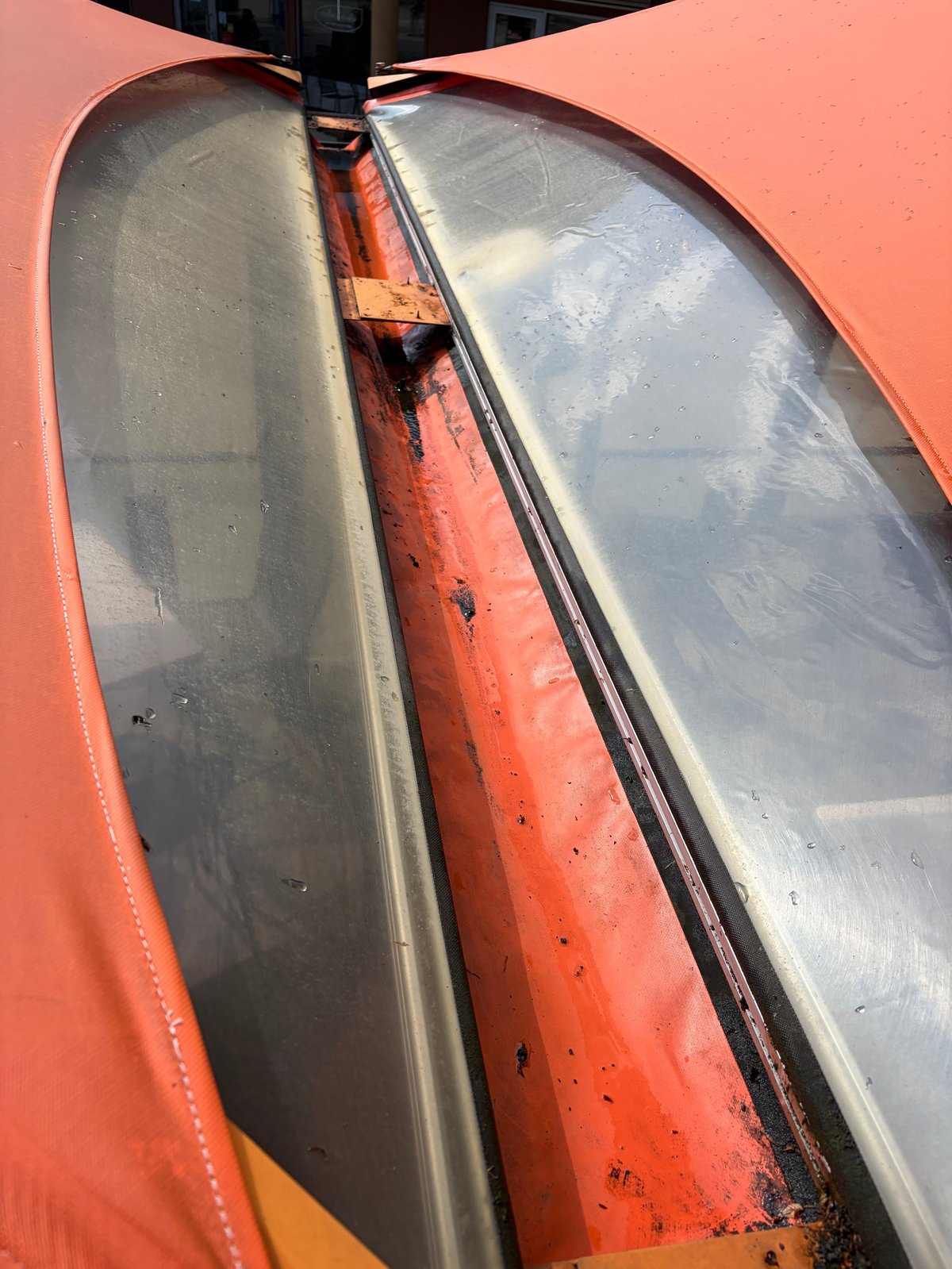 Close-up of dirty headlights on a red vehicle with oxidized and cloudy lenses
